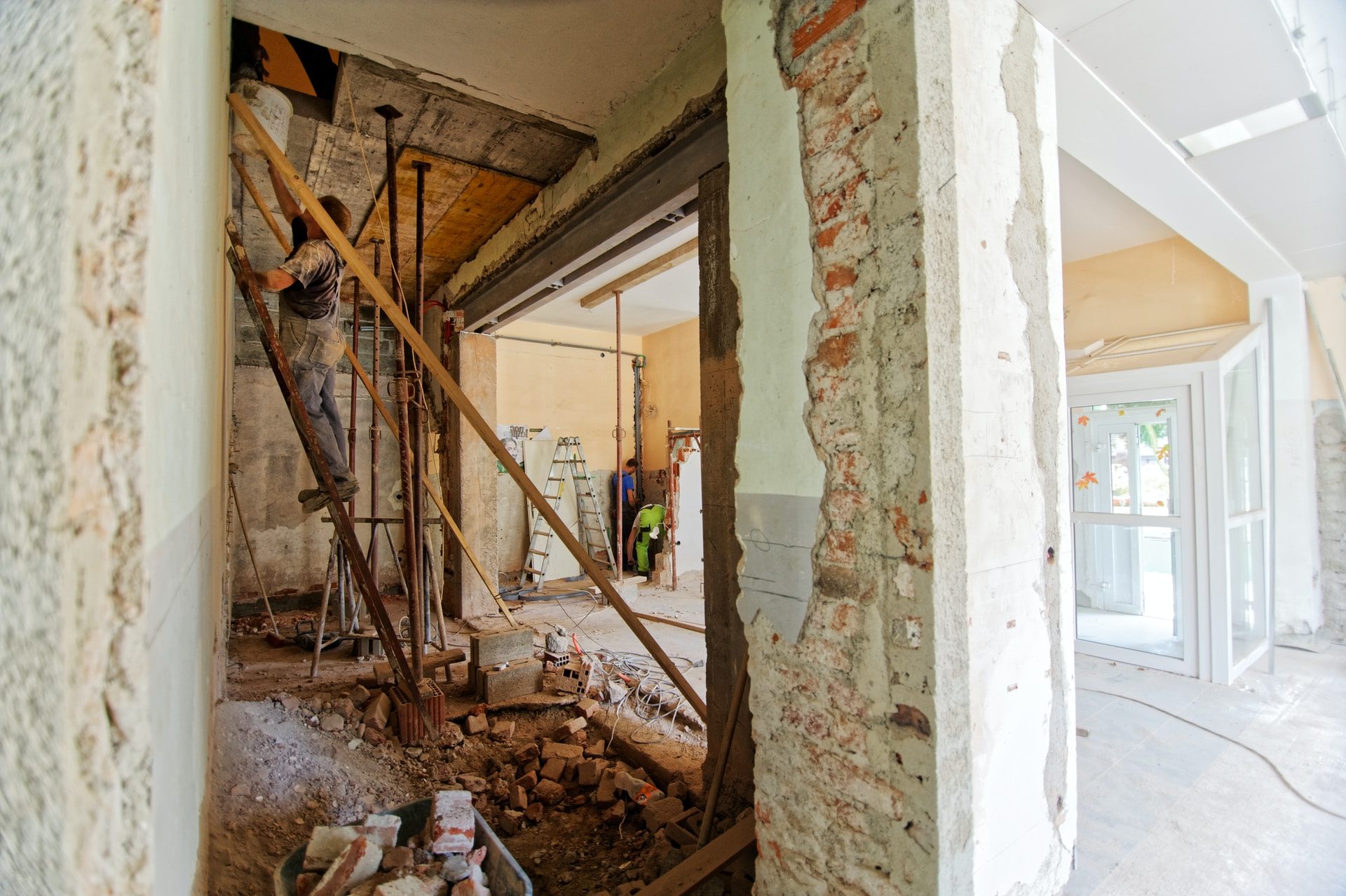 man climbing on ladder inside room